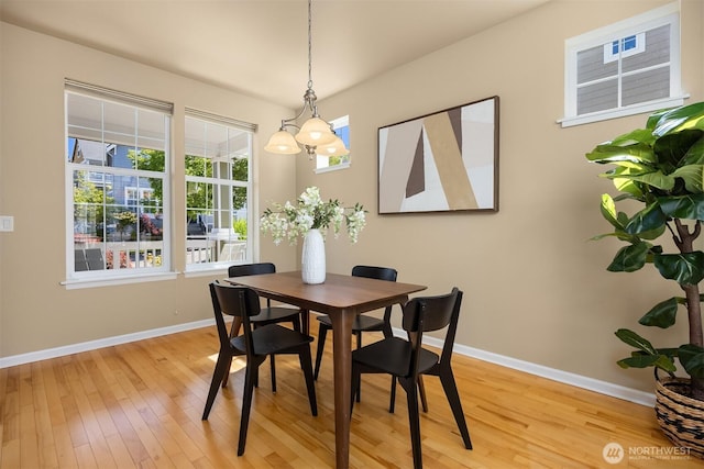 19799 NE Ash Crest Loop, Poulsbo, WA 98370 - dining space with light wood-style floors, baseboards, and a chandelier
