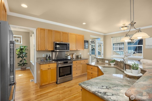19799 NE Ash Crest Loop, Poulsbo, WA 98370 - kitchen with stainless steel appliances, a sink, light wood-style flooring, crown molding, and light stone counters