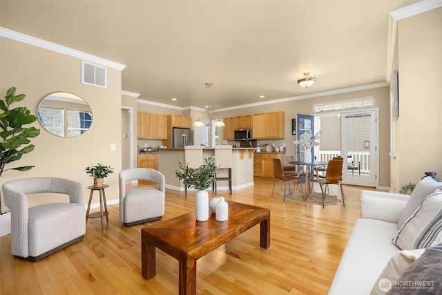 19799 NE Ash Crest Loop, Poulsbo, WA 98370 - living area with light wood-type flooring, healthy amount of natural light, crown molding, baseboards, and recessed lighting