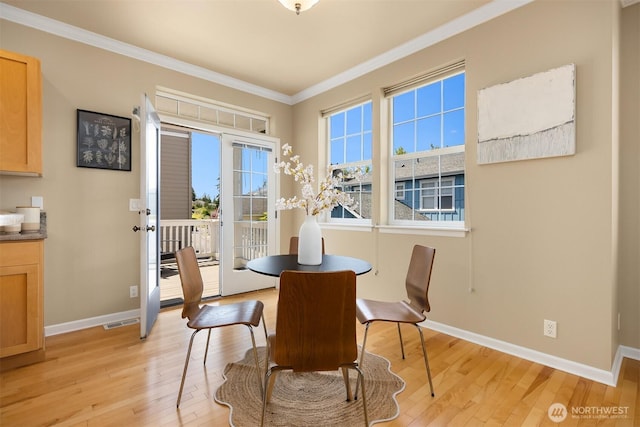 19799 NE Ash Crest Loop, Poulsbo, WA 98370 - dining room with light wood-style floors, crown molding, and baseboards