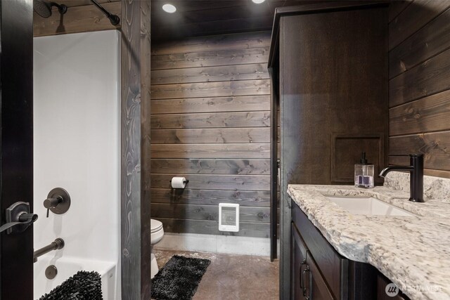335 Brown Rd, Chehalis, WA 98532 - bathroom with wood walls, toilet, vanity, tub / shower combination, and recessed lighting