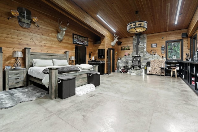335 Brown Rd, Chehalis, WA 98532 - bedroom featuring wooden walls, a wood stove, wooden ceiling, and concrete flooring