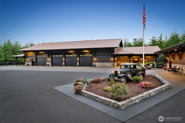 335 Brown Rd, Chehalis, WA 98532 - view of front of property featuring stone siding, asphalt driveway, metal roof, and a garage