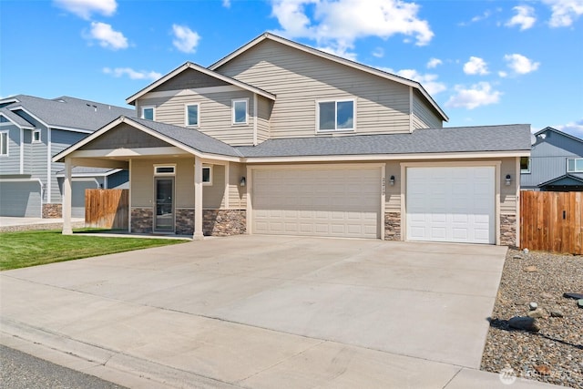 2212 N Creeksedge Way, Ellensburg, WA 98926 - view of front of home with concrete driveway, stone siding, a garage, and roof with shingles