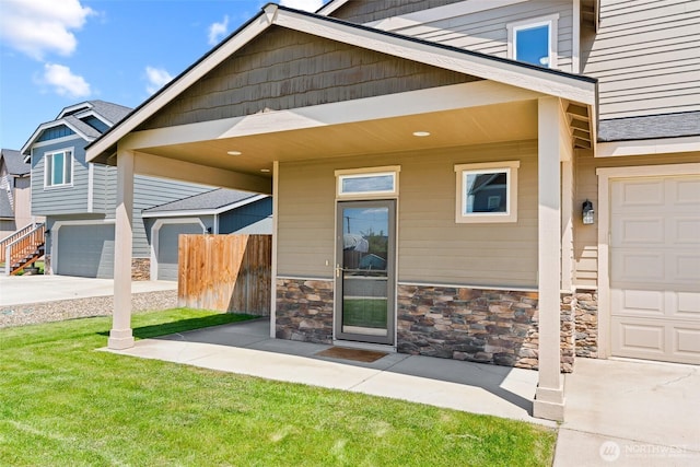 2212 N Creeksedge Way, Ellensburg, WA 98926 - doorway to property featuring stone siding, concrete driveway, and a garage