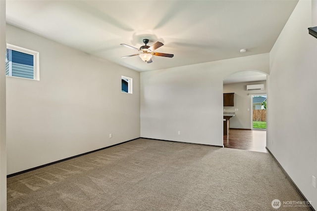 2212 N Creeksedge Way, Ellensburg, WA 98926 - unfurnished room featuring arched walkways, a wall mounted air conditioner, a ceiling fan, carpet floors, and baseboards