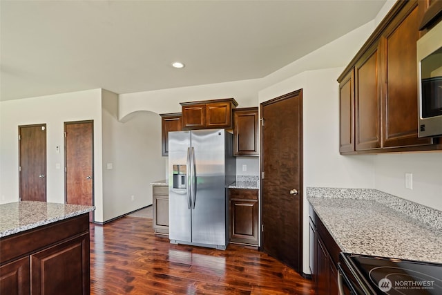 2212 N Creeksedge Way, Ellensburg, WA 98926 - kitchen featuring stainless steel appliances, dark wood-type flooring, light stone countertops, recessed lighting, and arched walkways