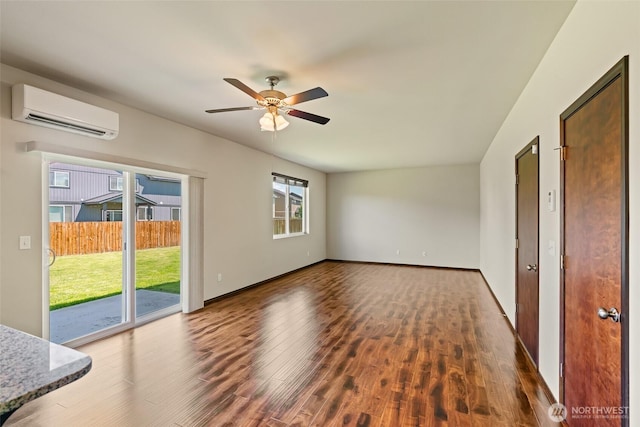 2212 N Creeksedge Way, Ellensburg, WA 98926 - unfurnished living room featuring a wall unit AC, wood finished floors, a ceiling fan, and baseboards