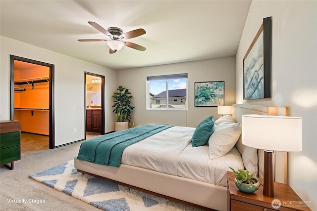 2212 N Creeksedge Way, Ellensburg, WA 98926 - carpeted bedroom with a spacious closet, connected bathroom, ceiling fan, and a closet
