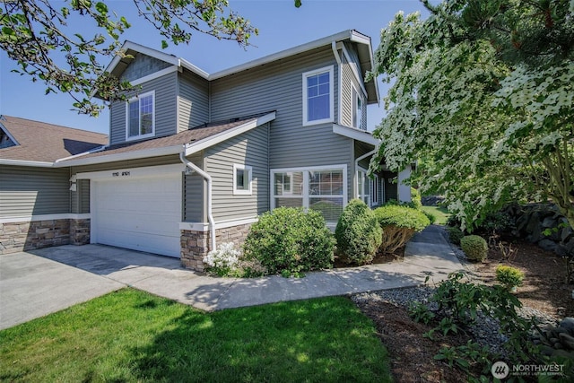 1110 63rd St E Unit 101, Auburn, WA 98092 - view of front of property featuring driveway, stone siding, an attached garage, and a shingled roof
