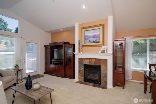 1110 63rd St E Unit 101, Auburn, WA 98092 - carpeted living area featuring lofted ceiling, plenty of natural light, a fireplace, baseboards, and recessed lighting