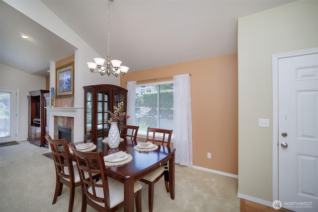 1110 63rd St E Unit 101, Auburn, WA 98092 - dining room with lofted ceiling, light carpet, a tiled fireplace, baseboards, and a chandelier