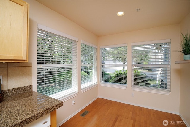 1110 63rd St E Unit 101, Auburn, WA 98092 - unfurnished dining area with healthy amount of natural light, light wood finished floors, baseboards, and recessed lighting
