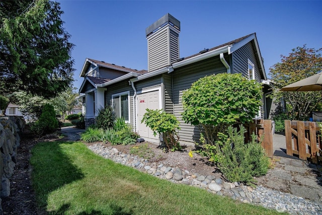 1110 63rd St E Unit 101, Auburn, WA 98092 - view of side of home featuring a chimney and a yard