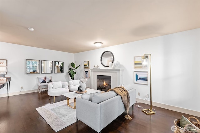 22910 90th Ave W Unit E406, Edmonds, WA 98026 - living room featuring dark wood-style flooring, a tiled fireplace, and baseboards