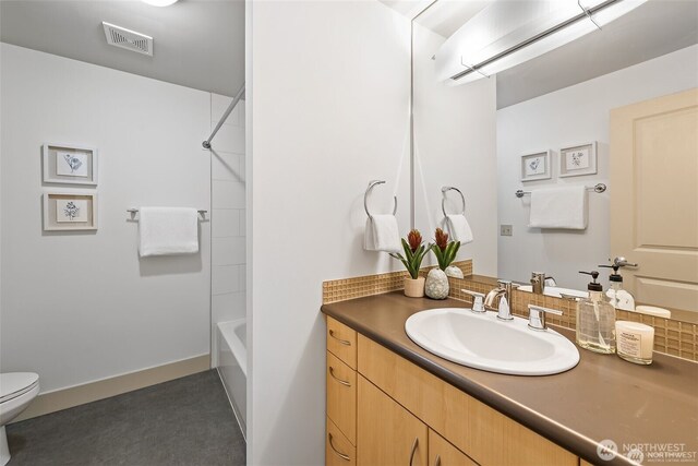 22910 90th Ave W Unit E406, Edmonds, WA 98026 - full bathroom with toilet, vanity, backsplash, and shower / washtub combination