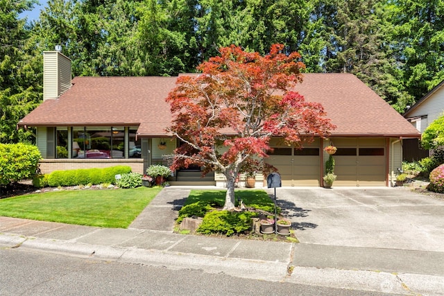 924 S 245th Pl, Des Moines, WA 98198 - view of front facade with a chimney, asphalt driveway, a front lawn, a shingled roof, and an attached garage