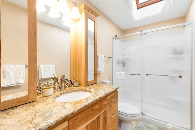 924 S 245th Pl, Des Moines, WA 98198 - full bathroom featuring a shower stall, vanity, a skylight, toilet, and tile patterned flooring