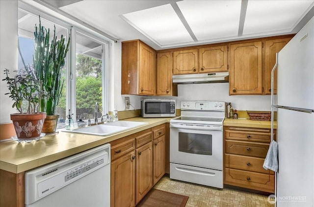 11611 NE 134th St, Kirkland, WA 98034 - kitchen featuring white appliances, under cabinet range hood, brown cabinetry, and light countertops