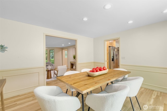 11750 NE 36th Pl, Bellevue, WA 98005 - dining space featuring a wainscoted wall, light wood-style floors, recessed lighting, and a decorative wall