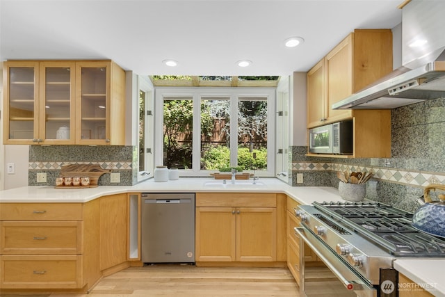 11750 NE 36th Pl, Bellevue, WA 98005 - kitchen with stainless steel appliances, wall chimney exhaust hood, light countertops, backsplash, and recessed lighting