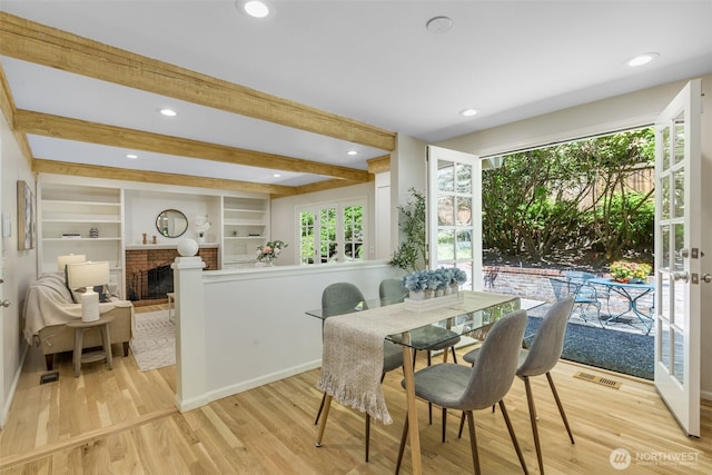 11750 NE 36th Pl, Bellevue, WA 98005 - dining space with a brick fireplace, light wood-type flooring, healthy amount of natural light, beamed ceiling, and recessed lighting