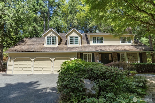 11750 NE 36th Pl, Bellevue, WA 98005 - view of front facade with asphalt driveway, an attached garage, and brick siding