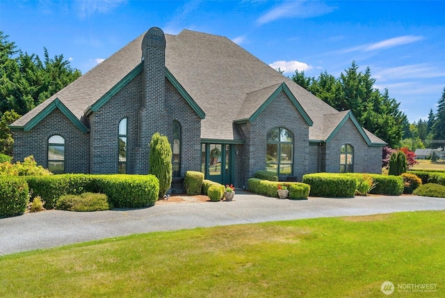 7212 Canterwood Dr SE, Olympia, WA 98513 - view of front of home featuring brick siding, a front yard, and a shingled roof