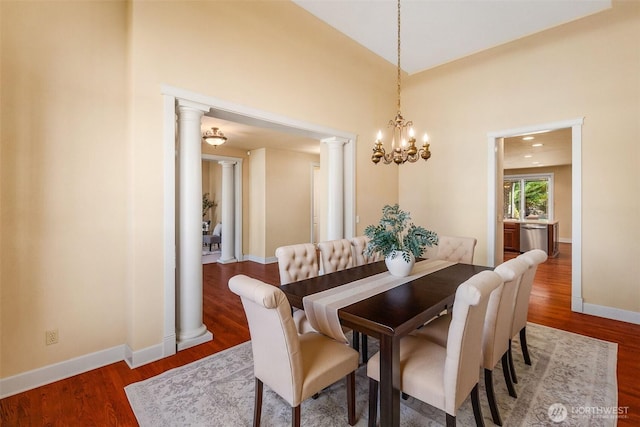 7212 Canterwood Dr SE, Olympia, WA 98513 - dining space with wood finished floors, ornate columns, and a chandelier