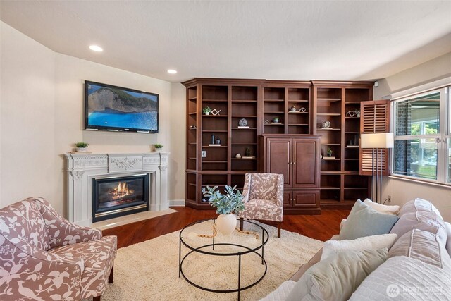 7212 Canterwood Dr SE, Olympia, WA 98513 - living area featuring dark wood-style floors, a glass covered fireplace, and recessed lighting