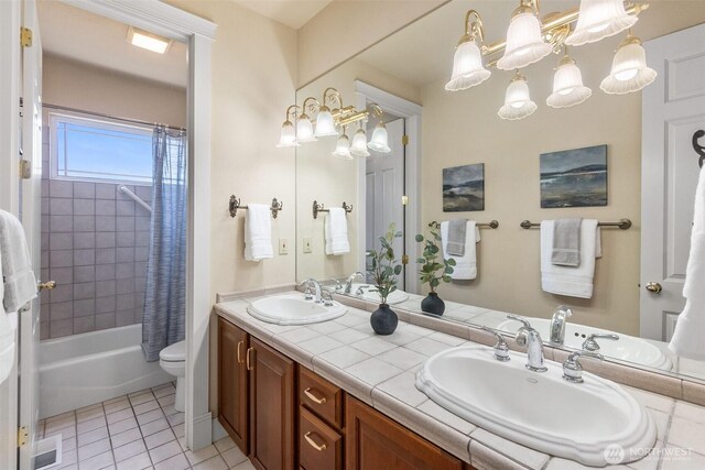 7212 Canterwood Dr SE, Olympia, WA 98513 - full bathroom with a chandelier, double vanity, shower / bath combination with curtain, and tile patterned flooring
