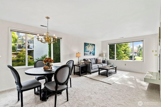 4152 Providence Point Dr SE Unit 207, Issaquah, WA 98029 - carpeted dining space featuring a chandelier and baseboards