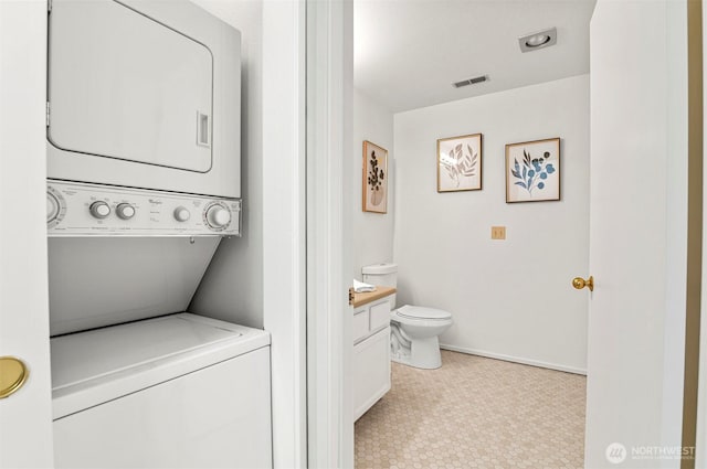 4152 Providence Point Dr SE Unit 207, Issaquah, WA 98029 - laundry room featuring stacked washer and clothes dryer and baseboards