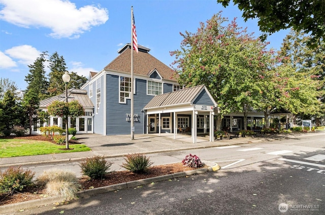 4152 Providence Point Dr SE Unit 207, Issaquah, WA 98029 - rear view of property featuring a standing seam roof, metal roof, and uncovered parking