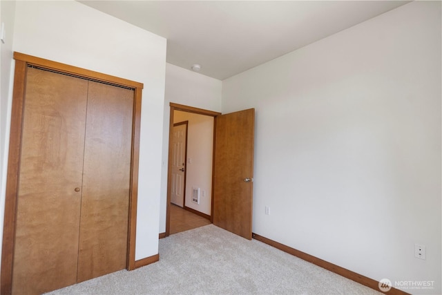 910 Gladstone St Unit 307, Bellingham, WA 98229 - unfurnished bedroom featuring carpet flooring, baseboards, and a closet