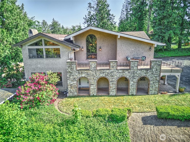 13311 SE 290th St, Auburn, WA 98092 - view of front of property with stucco siding, stone siding, a front lawn, and a balcony