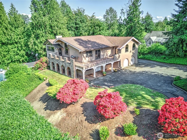 13311 SE 290th St, Auburn, WA 98092 - view of front facade featuring stucco siding, stone siding, a chimney, asphalt driveway, and a garage