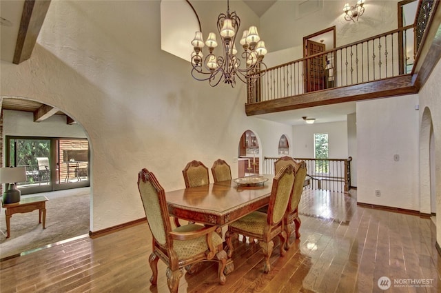 13311 SE 290th St, Auburn, WA 98092 - dining space with a textured wall, wood finished floors, a high ceiling, a chandelier, and baseboards