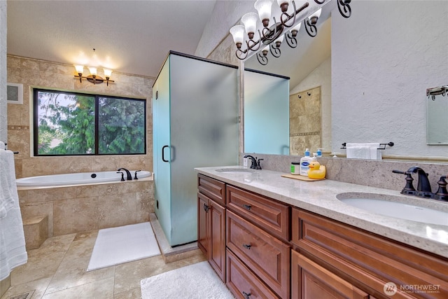 13311 SE 290th St, Auburn, WA 98092 - full bathroom featuring a chandelier, double vanity, a bath, a stall shower, and a textured wall
