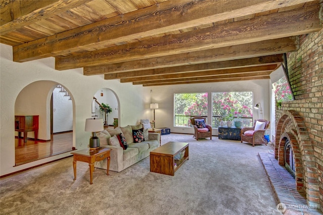 13311 SE 290th St, Auburn, WA 98092 - carpeted living area with wood ceiling with exposed beams, arched walkways, and a fireplace
