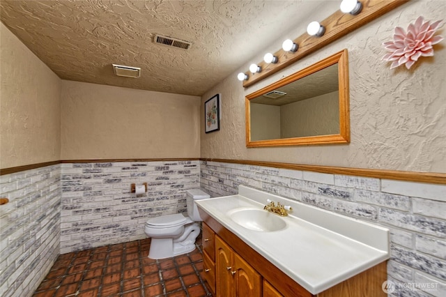 13311 SE 290th St, Auburn, WA 98092 - bathroom with vanity, toilet, wainscoting, a textured wall, and a textured ceiling
