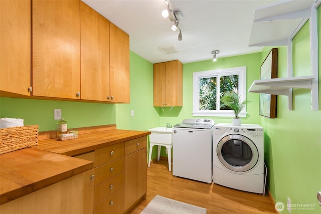 2330 NE 103rd St, Seattle, WA 98125 - laundry room with separate washer and dryer, light wood-style flooring, rail lighting, and cabinet space