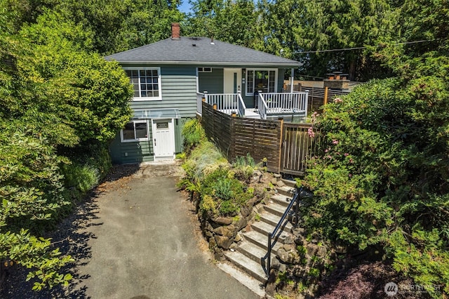 2330 NE 103rd St, Seattle, WA 98125 - bungalow featuring stairway, a chimney, roof with shingles, and covered porch