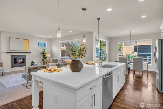 3071 S 276th Ct, Auburn, WA 98001 - kitchen featuring stainless steel appliances, open floor plan, a kitchen island with sink, recessed lighting, and white cabinetry