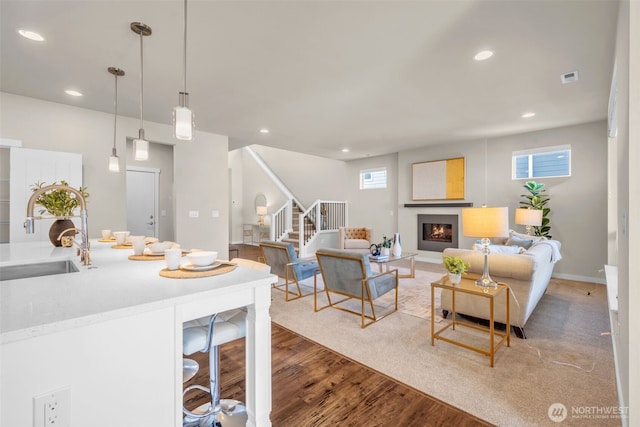 3071 S 276th Ct, Auburn, WA 98001 - living room featuring stairway, plenty of natural light, light wood-style floors, a glass covered fireplace, and recessed lighting