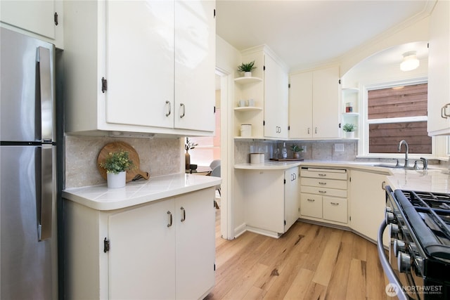 1536 NE 95th St, Seattle, WA 98115 - kitchen with open shelves, freestanding refrigerator, gas stove, a sink, and light countertops