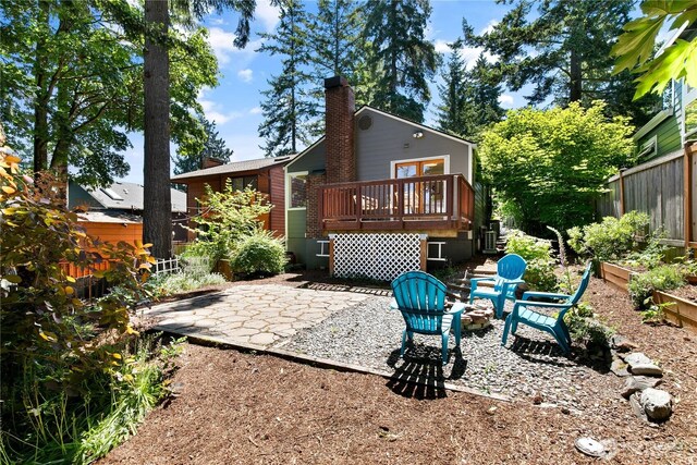 1536 NE 95th St, Seattle, WA 98115 - rear view of house featuring a deck, a patio area, and a chimney