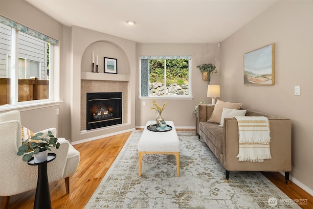 3316 Main Ave S, Renton, WA 98055 - living room with wood finished floors, a tiled fireplace, and baseboards