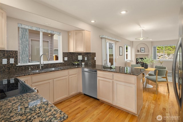 3316 Main Ave S, Renton, WA 98055 - kitchen featuring appliances with stainless steel finishes, a sink, light wood-style flooring, a peninsula, and recessed lighting