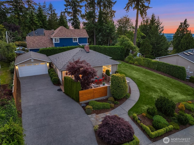4439 158th Ave SE, Bellevue, WA 98006 - view of front of home with driveway, a chimney, a fenced front yard, and a garage